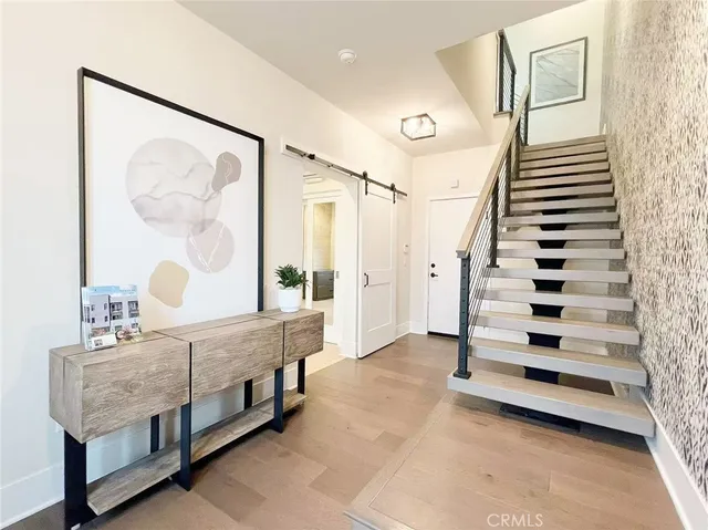 a view of front door and bedroom with furniture