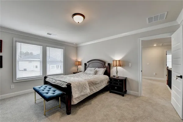 a bedroom with a bed and a chair