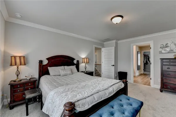 a bedroom with a bed and a lamp