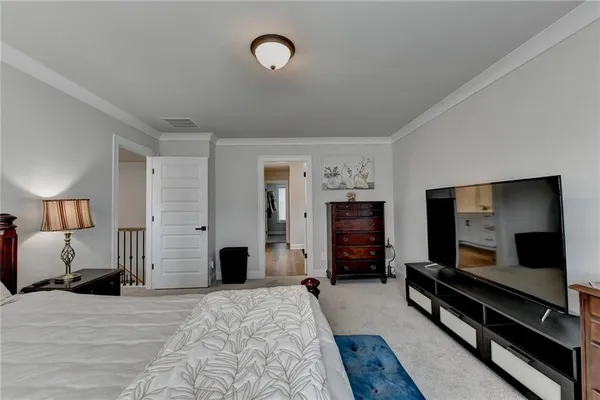 a bedroom with a bed and a television in it