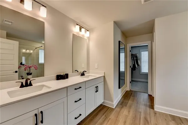 a bathroom with a double vanity sink and mirror