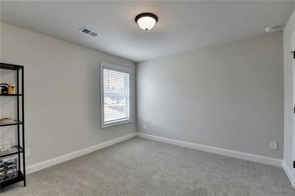 an empty room with windows and closet