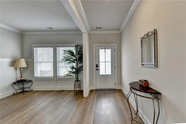 a view of a room with wooden floor and windows