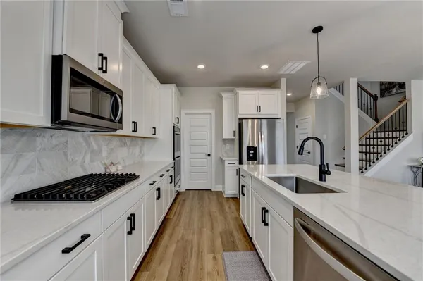 a kitchen with stainless steel appliances a sink stove and refrigerator