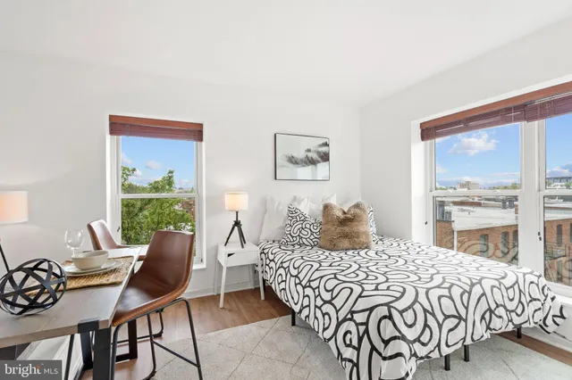 a bedroom with a large bed and a large window