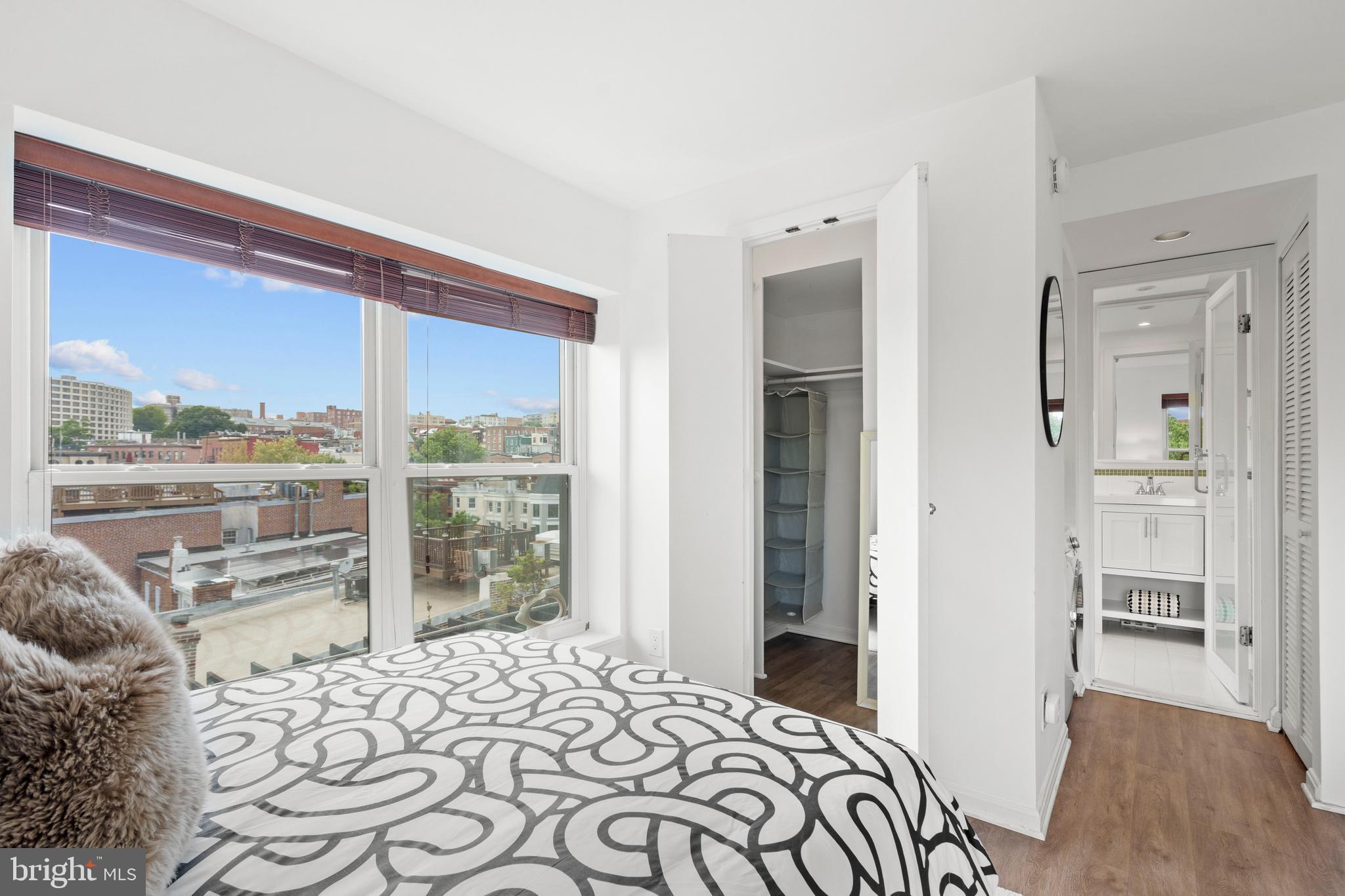 1736 Willard Street Northwest, Unit 506 Washington, DC 20009 - Photo 18 of 28 a bedroom with a bed and a large window with outer view