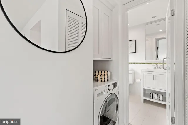 a bathroom with a granite countertop toilet sink and mirror