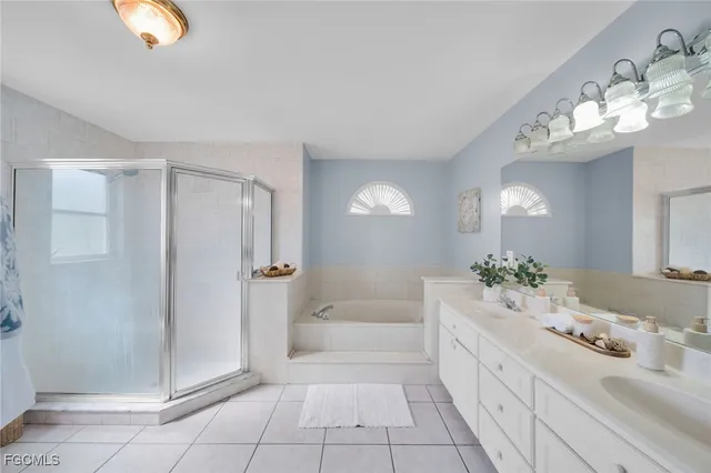 a spacious bathroom with a double vanity sink and a mirror