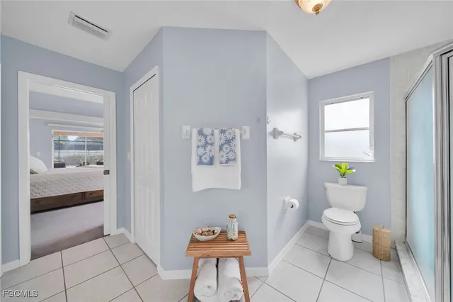 a bathroom with a toilet and a shower