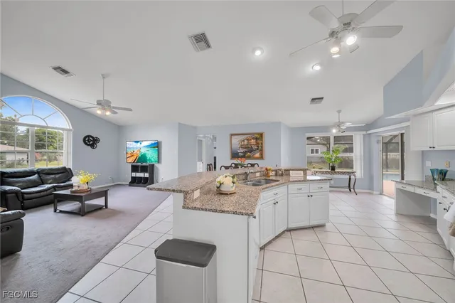 a kitchen with sink and living room view