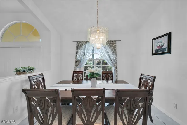 a view of a dining room with furniture and chandelier