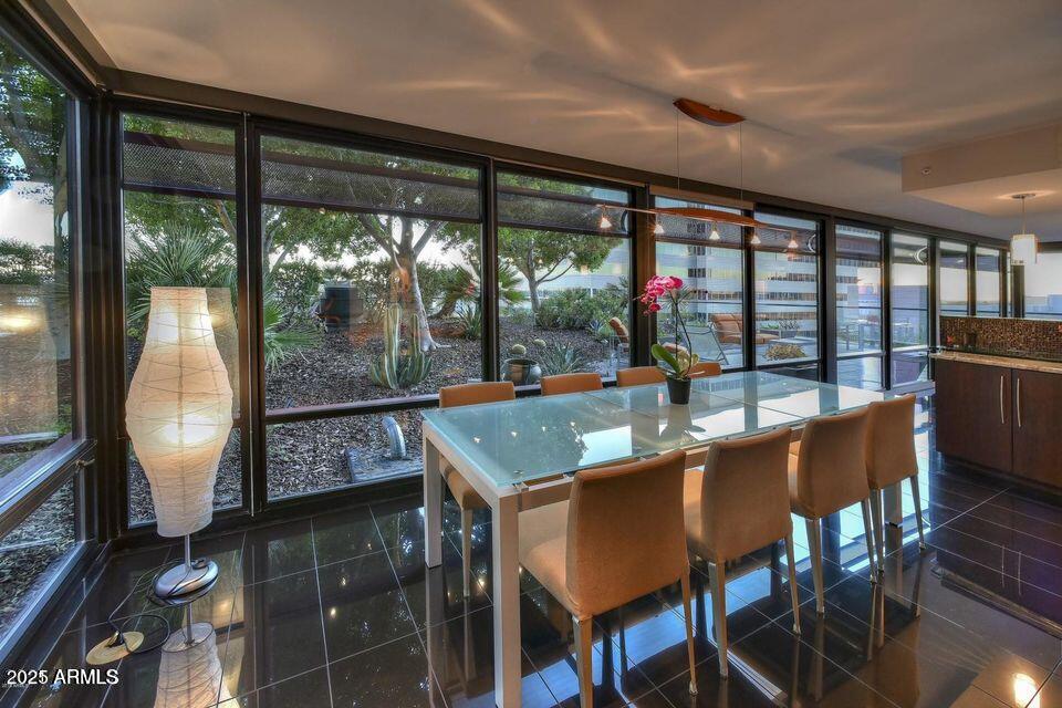 4808 North 24th Street, Unit 627 Phoenix, AZ 85016 - Photo 13 of 57 a room with stainless steel appliances granite countertop a table chairs and a glass door