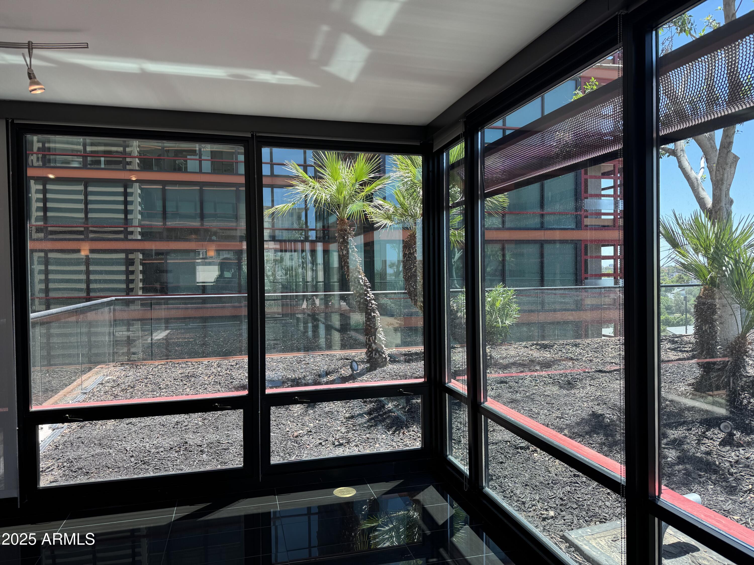 4808 North 24th Street, Unit 627 Phoenix, AZ 85016 - Photo 14 of 57 a view of a glass door with a balcony