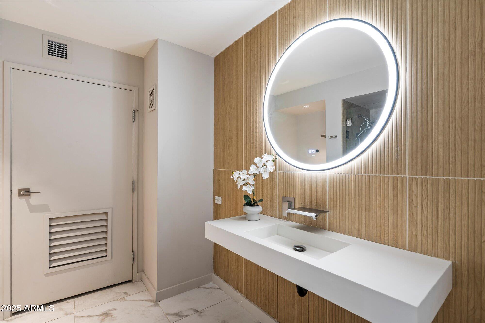 4808 North 24th Street, Unit 627 Phoenix, AZ 85016 - Photo 32 of 57 a bathroom with a sink and a mirror