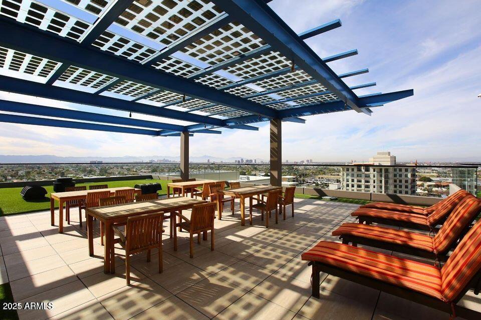 4808 North 24th Street, Unit 627 Phoenix, AZ 85016 - Photo 49 of 57 a view of a roof deck with a table and chairs
