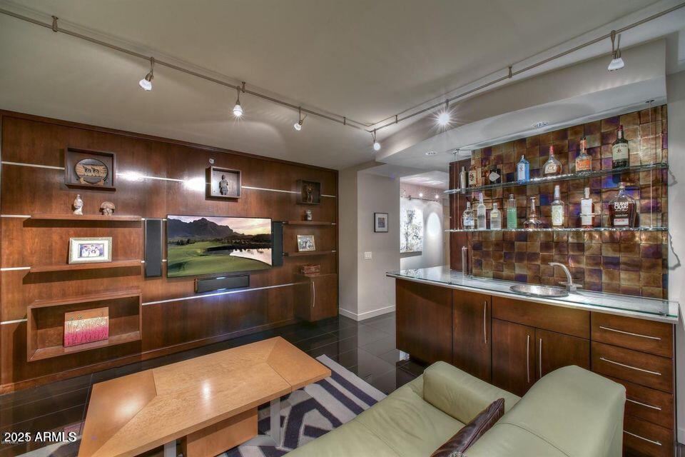 4808 North 24th Street, Unit 627 Phoenix, AZ 85016 - Photo 7 of 57 a kitchen with stainless steel appliances kitchen island granite countertop a refrigerator and wooden cabinets