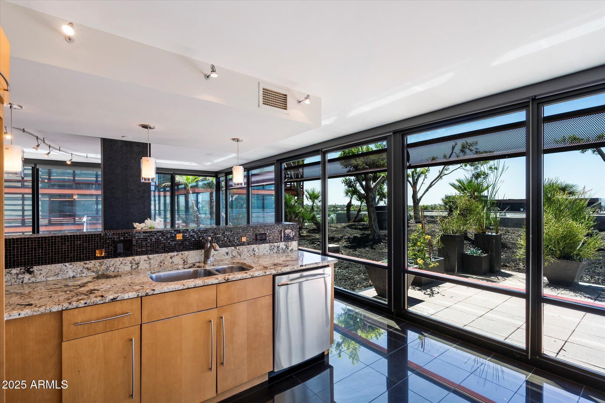 4808 North 24th Street, Unit 627 Phoenix, AZ 85016 - Photo 10 of 57 a kitchen with a large window and a sink