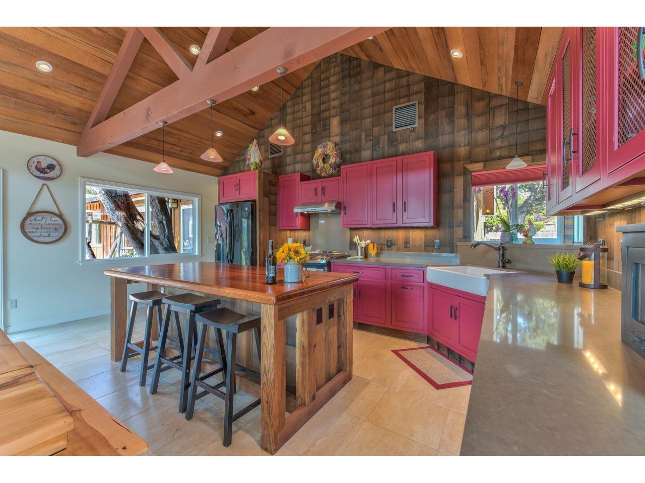 308 West Carmel Valley Road Carmel Valley, CA 93924 - Photo 14 of 49 a kitchen with stainless steel appliances kitchen island granite countertop a table chairs and a dining table