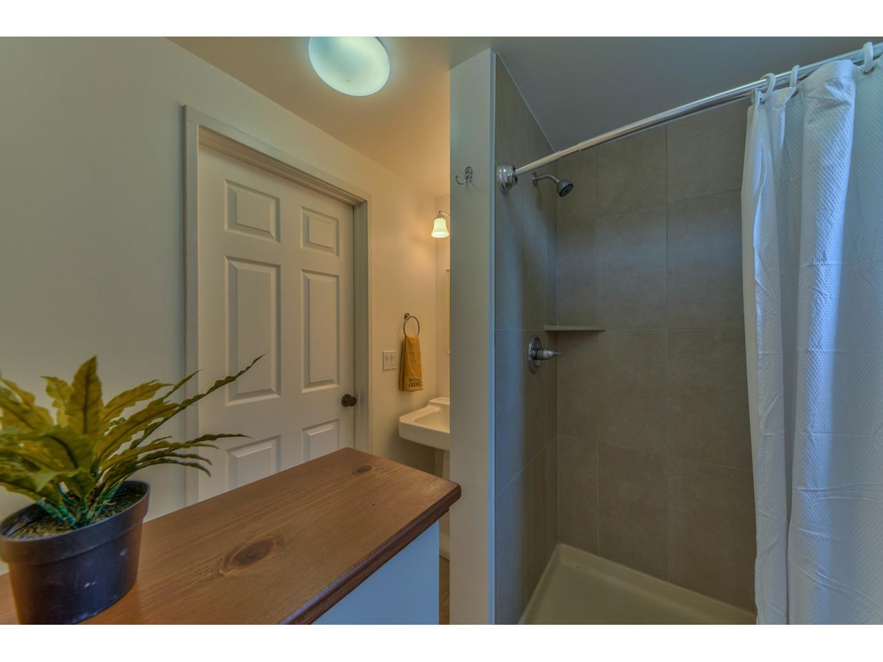 308 West Carmel Valley Road Carmel Valley, CA 93924 - Photo 39 of 49 a bathroom with a sink a mirror and a shower