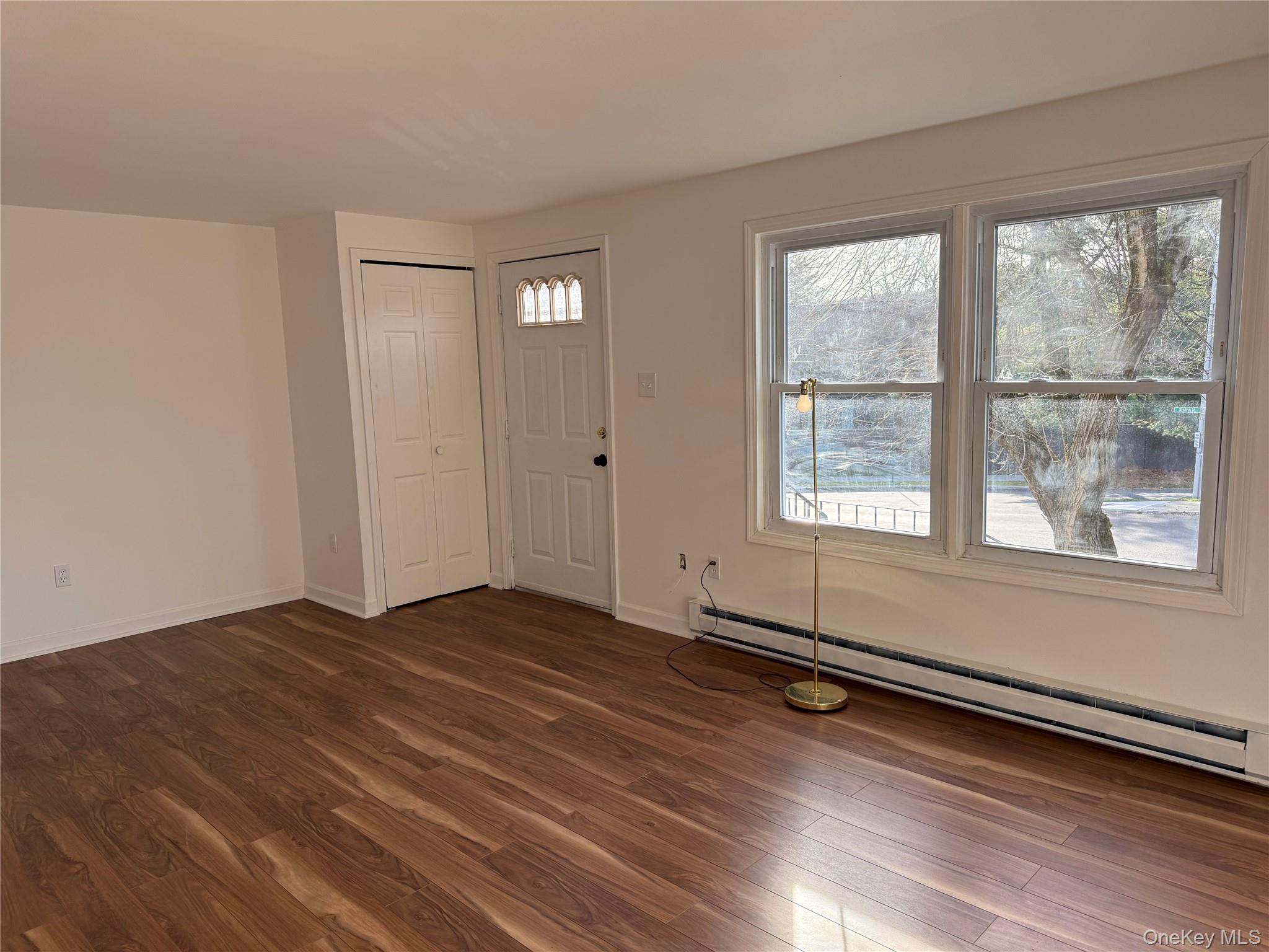 81 Gerald Drive Poughkeepsie, NY 12601 - Photo 3 of 20 an empty room with wooden floor and windows