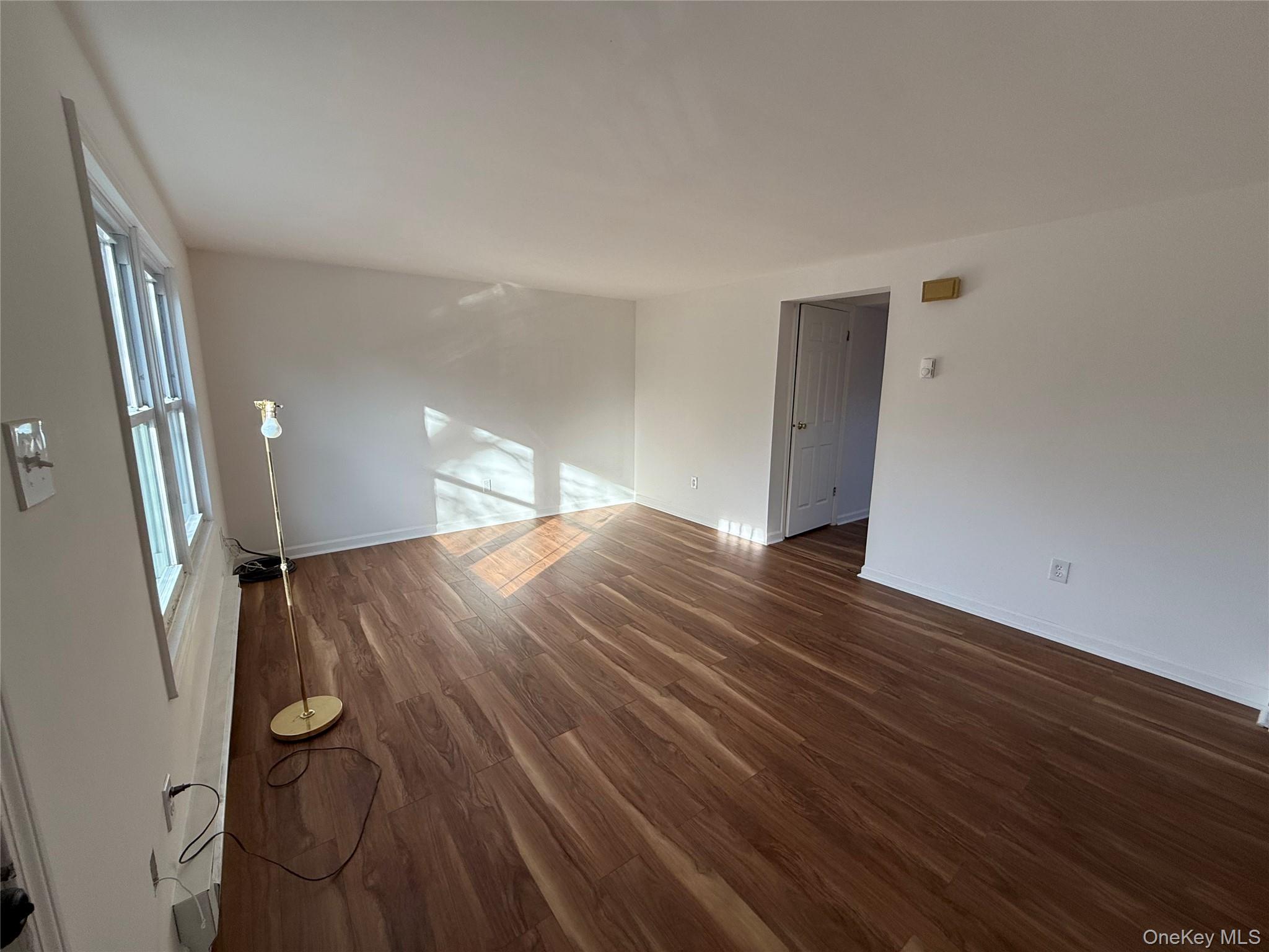 81 Gerald Drive Poughkeepsie, NY 12601 - Photo 4 of 20 a view of an empty room with wooden floor and a window