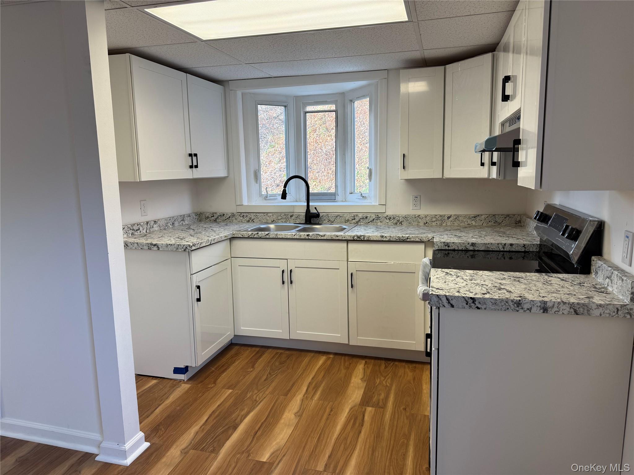 81 Gerald Drive Poughkeepsie, NY 12601 - Photo 6 of 20 a kitchen with a sink stove and cabinets