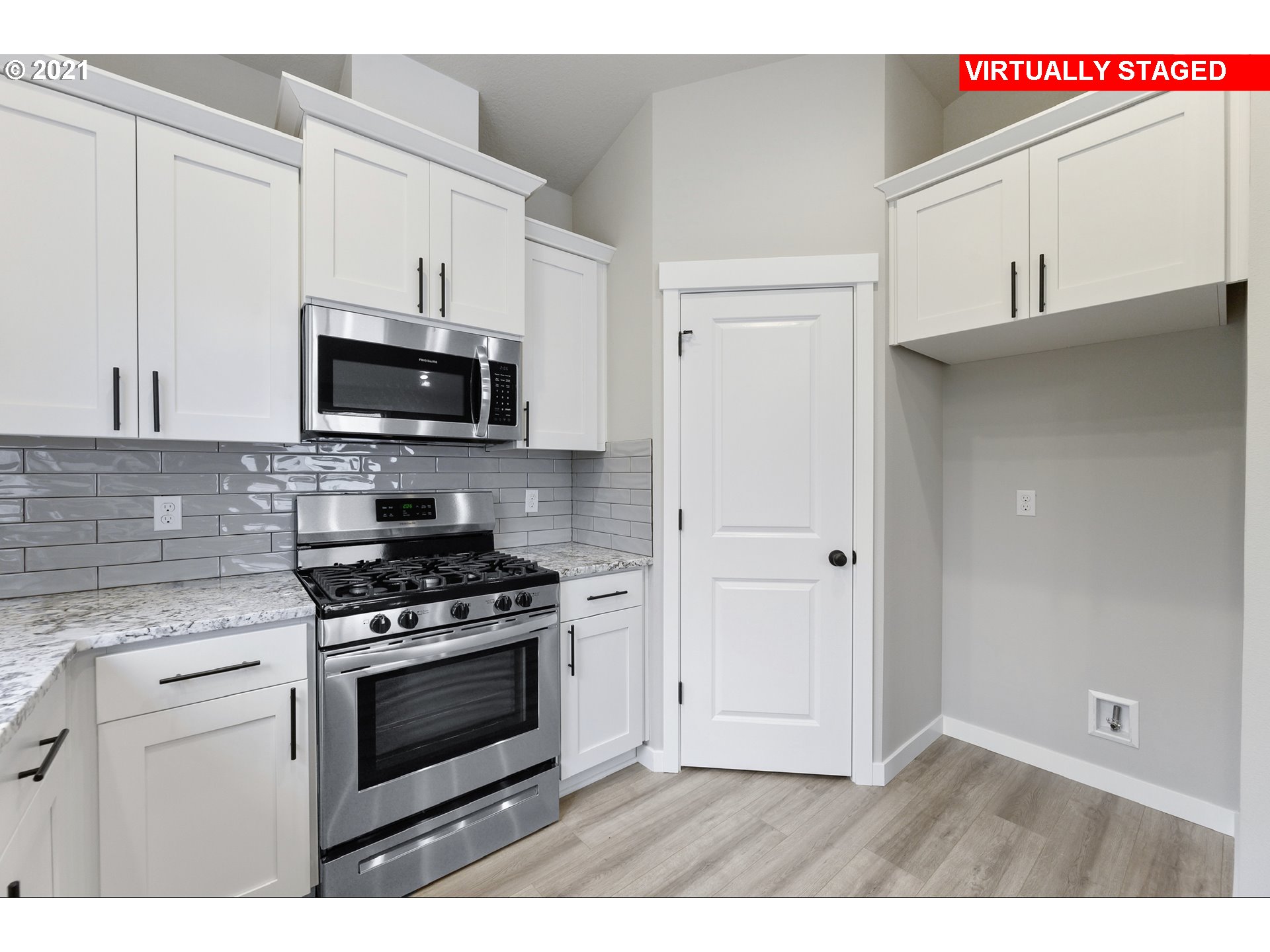 8528 North 5th Street, Unit LT31 Ridgefield, WA 98642 - Photo 7 of 31 a kitchen with stainless steel appliances a stove a microwave and sink