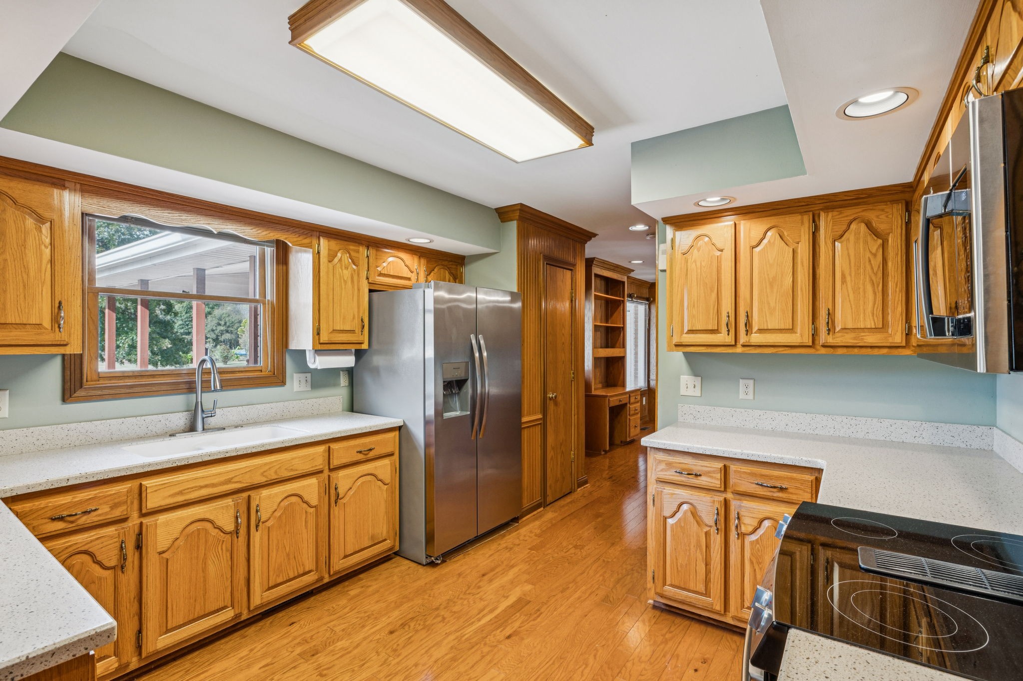 7935 Old Springfield Pike Goodlettsville, TN 37072 - Photo 22 of 82 a kitchen with refrigerator a stove a sink and dishwasher with wooden floor