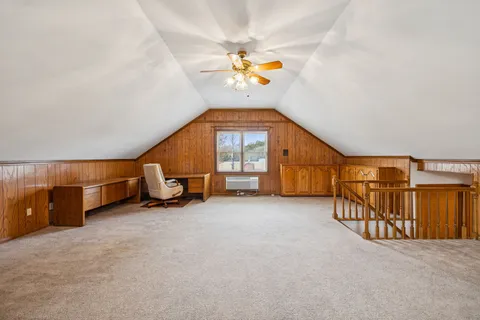 an empty room with wooden floor and a window