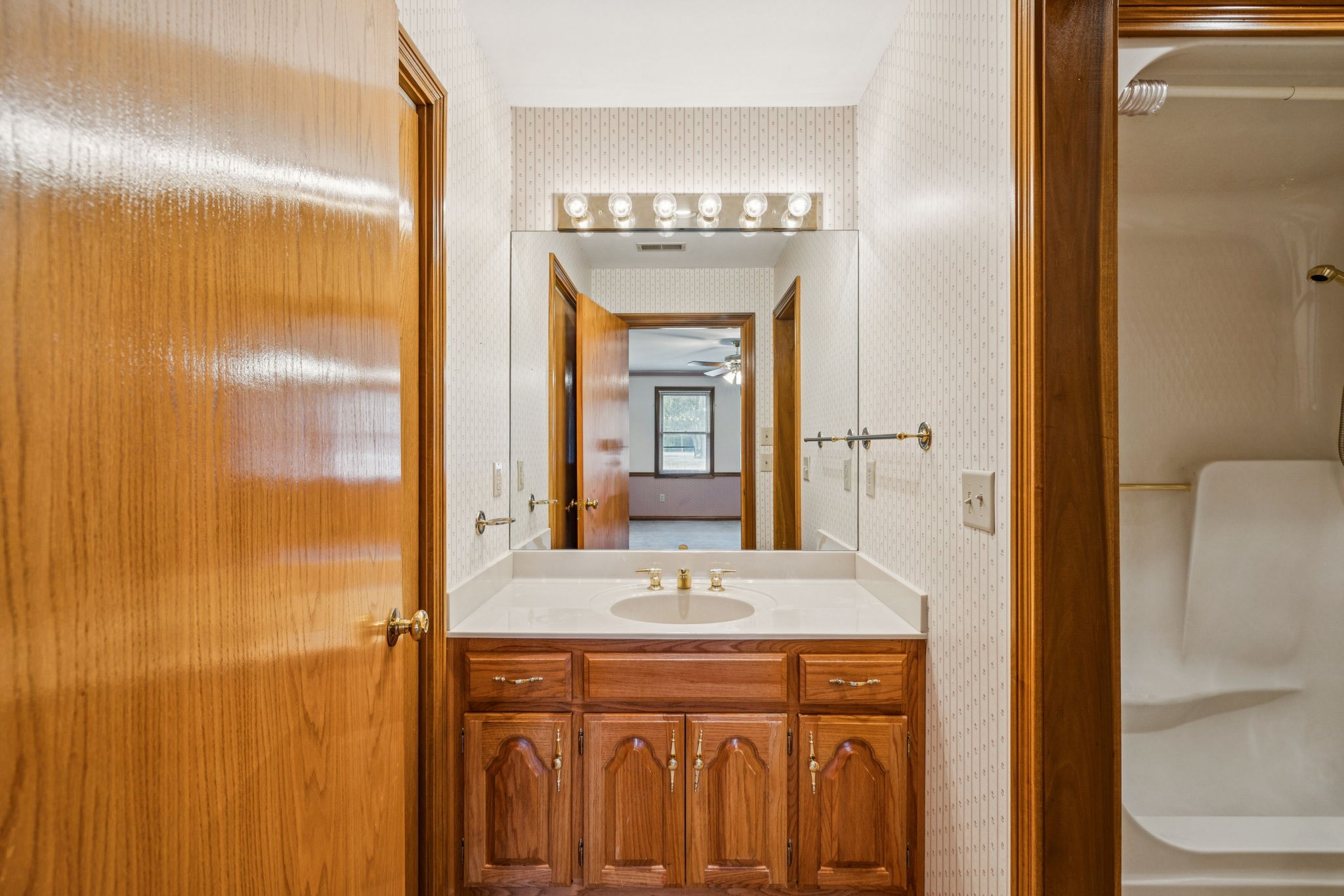 7935 Old Springfield Pike Goodlettsville, TN 37072 - Photo 38 of 82 a bathroom with a granite countertop sink a mirror and a shower