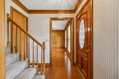 a view of an empty room with a fireplace and a window