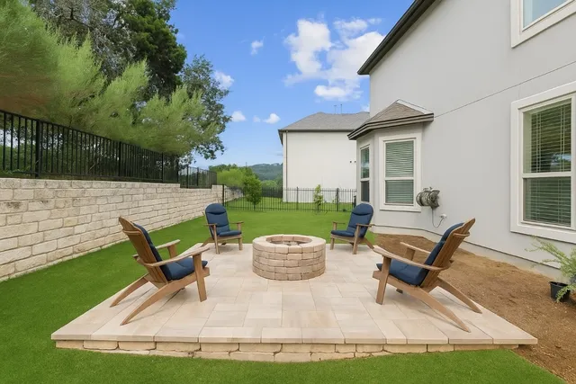a view of a patio with table and chairs with wooden fence and plants
