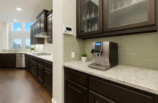 a kitchen with stainless steel appliances granite countertop a sink stove and cabinets