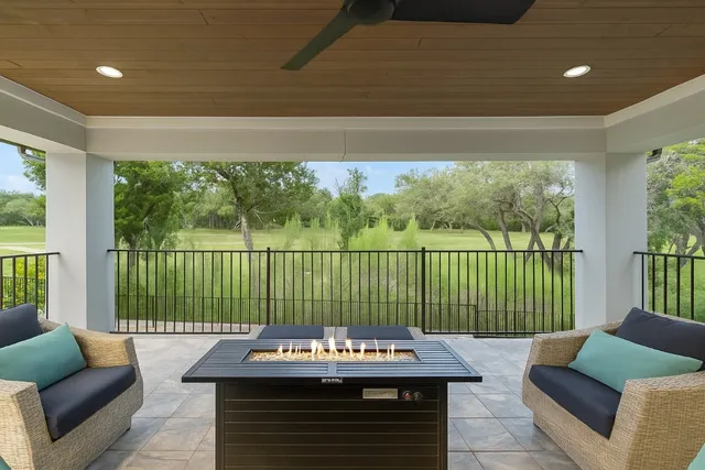 a living room with furniture and a floor to ceiling window