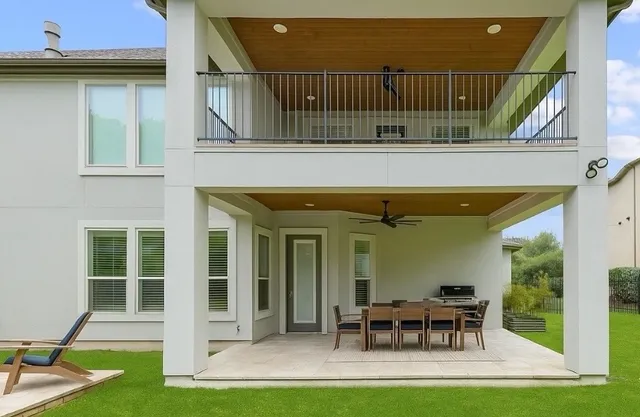 a backyard of a house with yard and outdoor seating