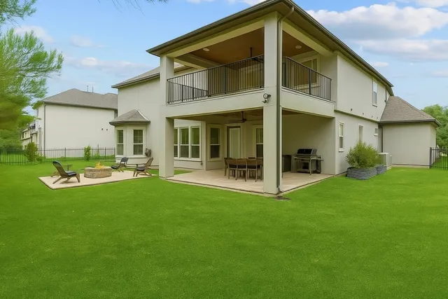 a view of a house with backyard porch and sitting area
