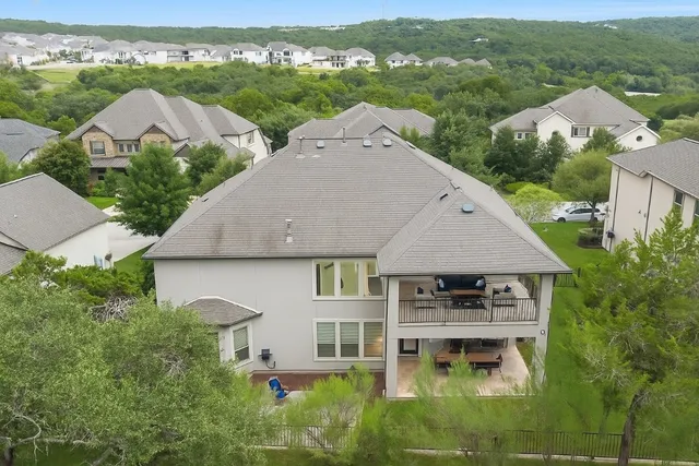 an aerial view of multiple houses with a yard