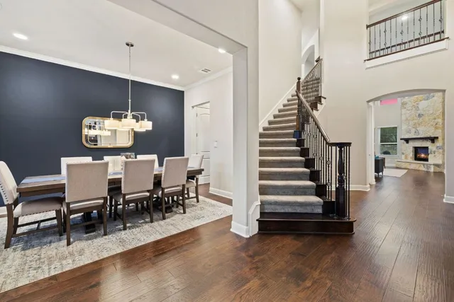 a view of a dining room with wooden floor and stairs