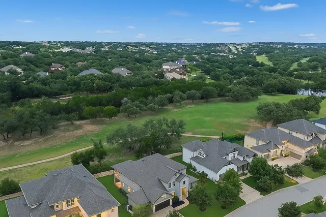 an aerial view of residential houses with outdoor space and street view