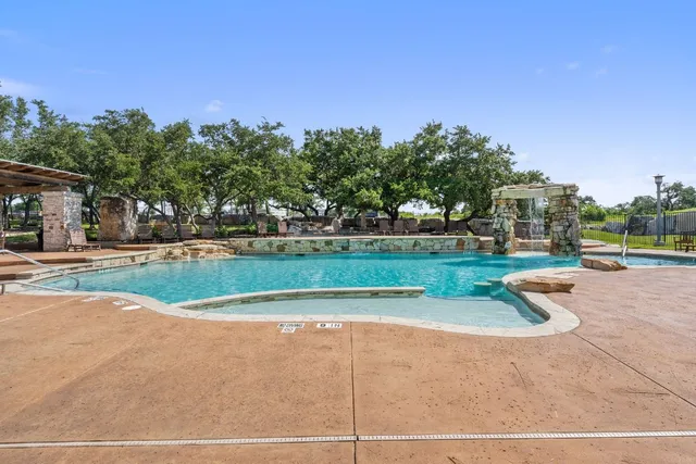 a view of a swimming pool with a patio