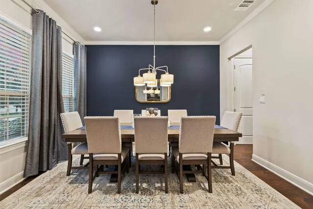 a dining room with furniture wooden floor and a chandelier