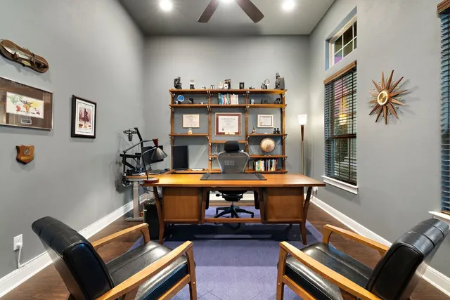 a living room with furniture and a piano
