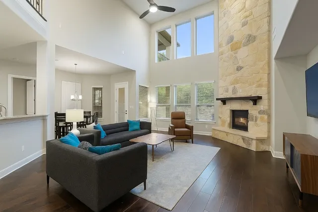 a living room with fireplace furniture and a wooden floor