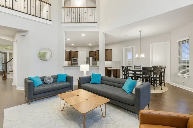 a living room with furniture and view of kitchen
