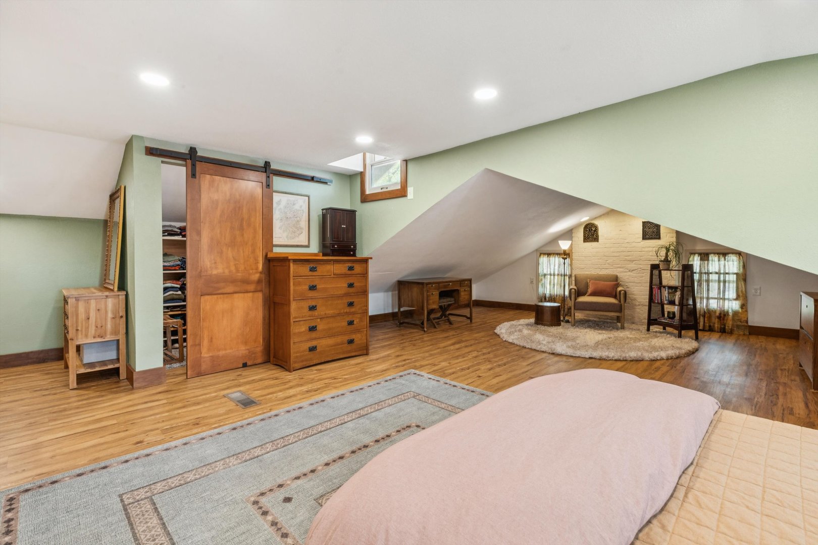 1818 23rd Street Rock Island, IL 61201 - Photo 31 of 55 a spacious bedroom with a bed a dresser and wooden floor
