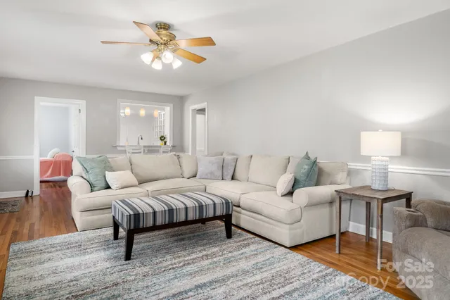 a living room with furniture and a chandelier