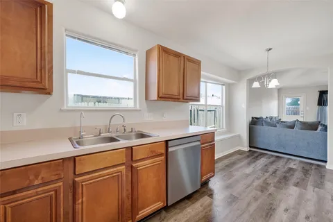 a large kitchen with kitchen island a sink stainless steel appliances and cabinets