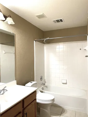 a bathroom with a double vanity sink toilet mirror and bathtub