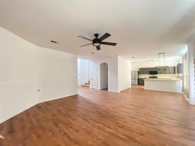 a view of a kitchen with a sink and a refrigerator