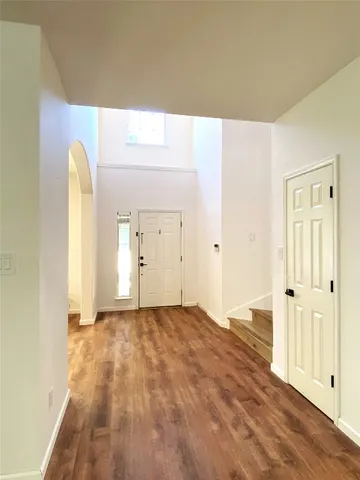 a view of a room with wooden floor